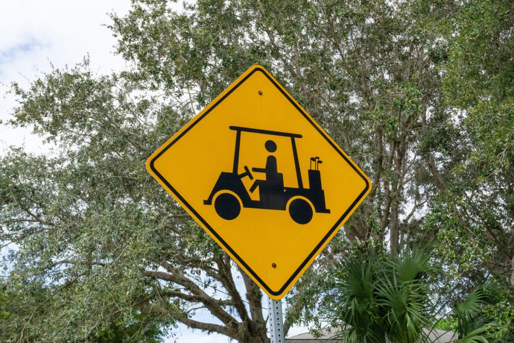 Golf cart crossing sign in tropical Florida
