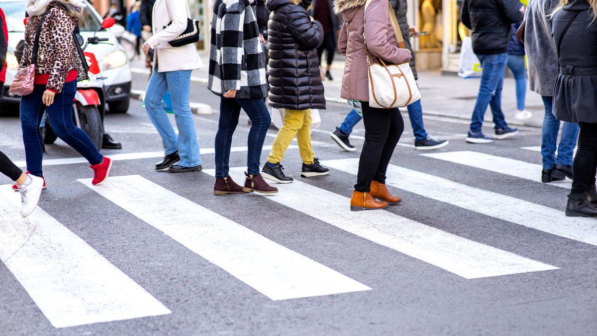 Pedestrians crossing pedestrian walkway in the city